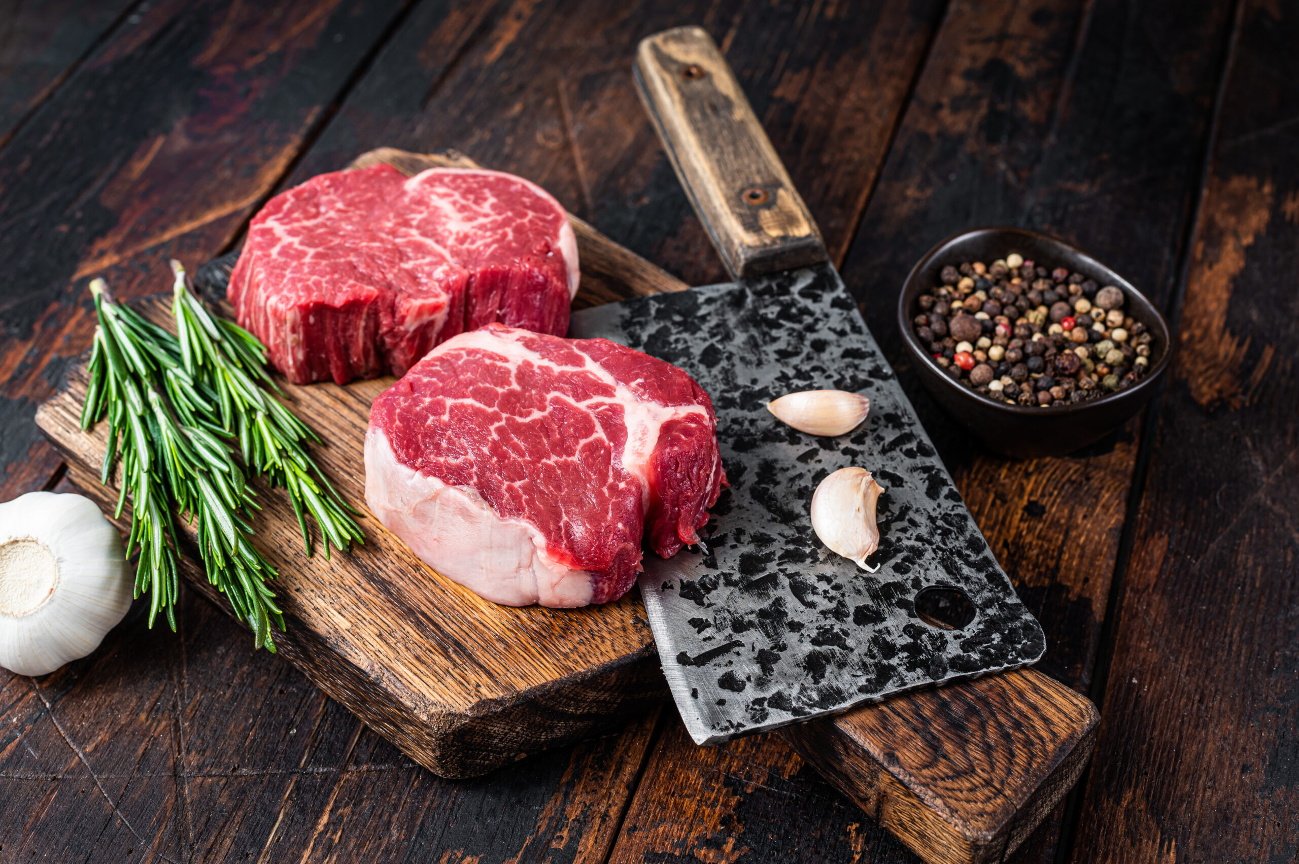 Fresh Raw Fillet Mignon tenderloin steaks on butcher cutting boa